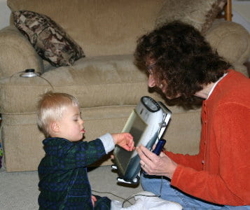 young child with AAC device