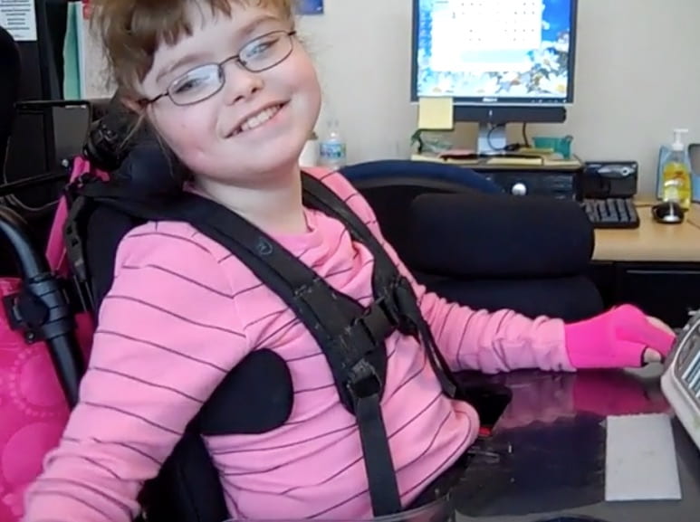girl with AAC device