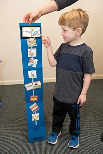 Child looks at visual schedule